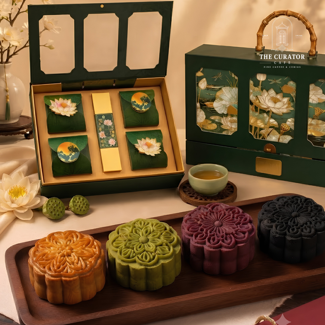 Hộp LOTUS mở ra, bánh đặt trên lá sen ép, hộp trà ở giữa